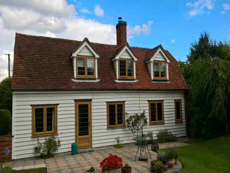 Wood-Effect-UPVC-Windows Golden oak wood effect UPVC windows in a dormer cottage